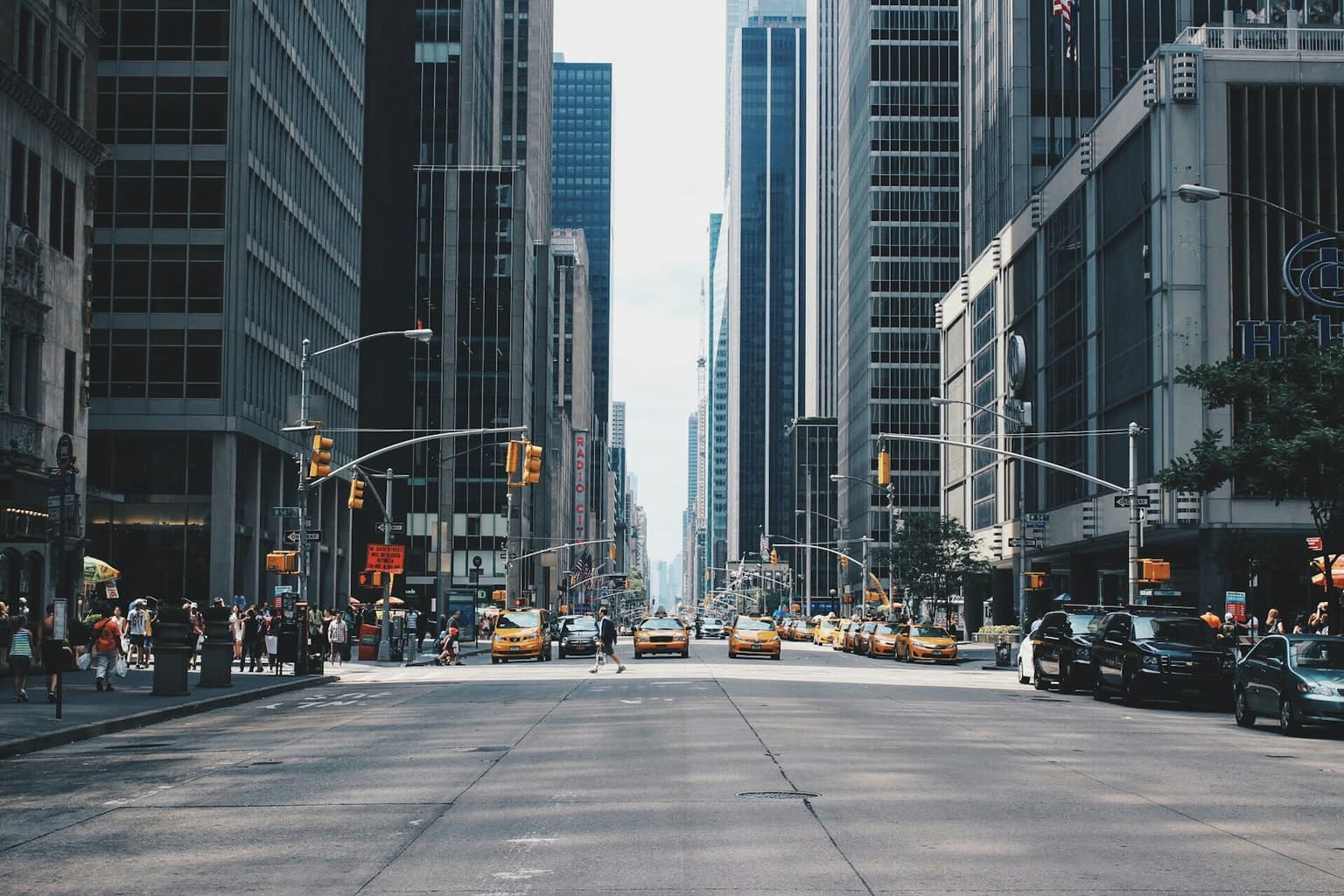 Busy city avenue lined with tall buildings
