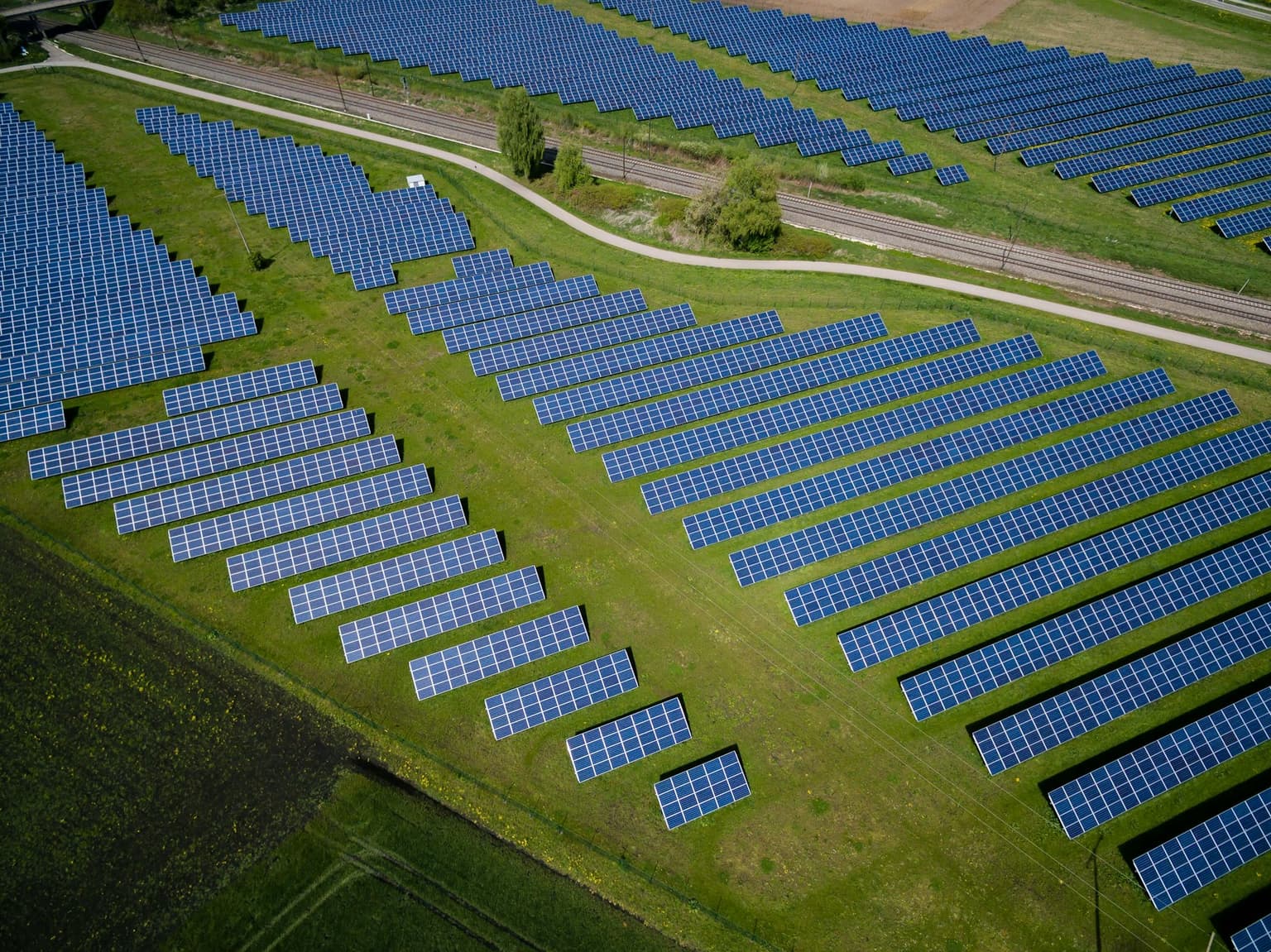 Rows of solar panels in an open field